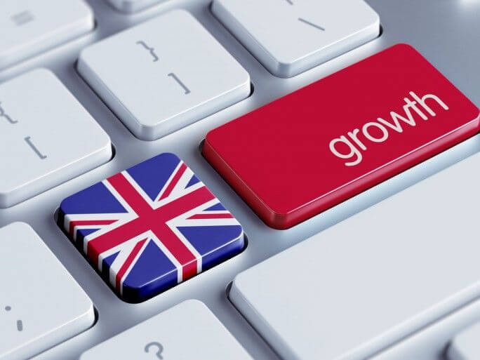 UK flag button and red growth button on computer keyboard.