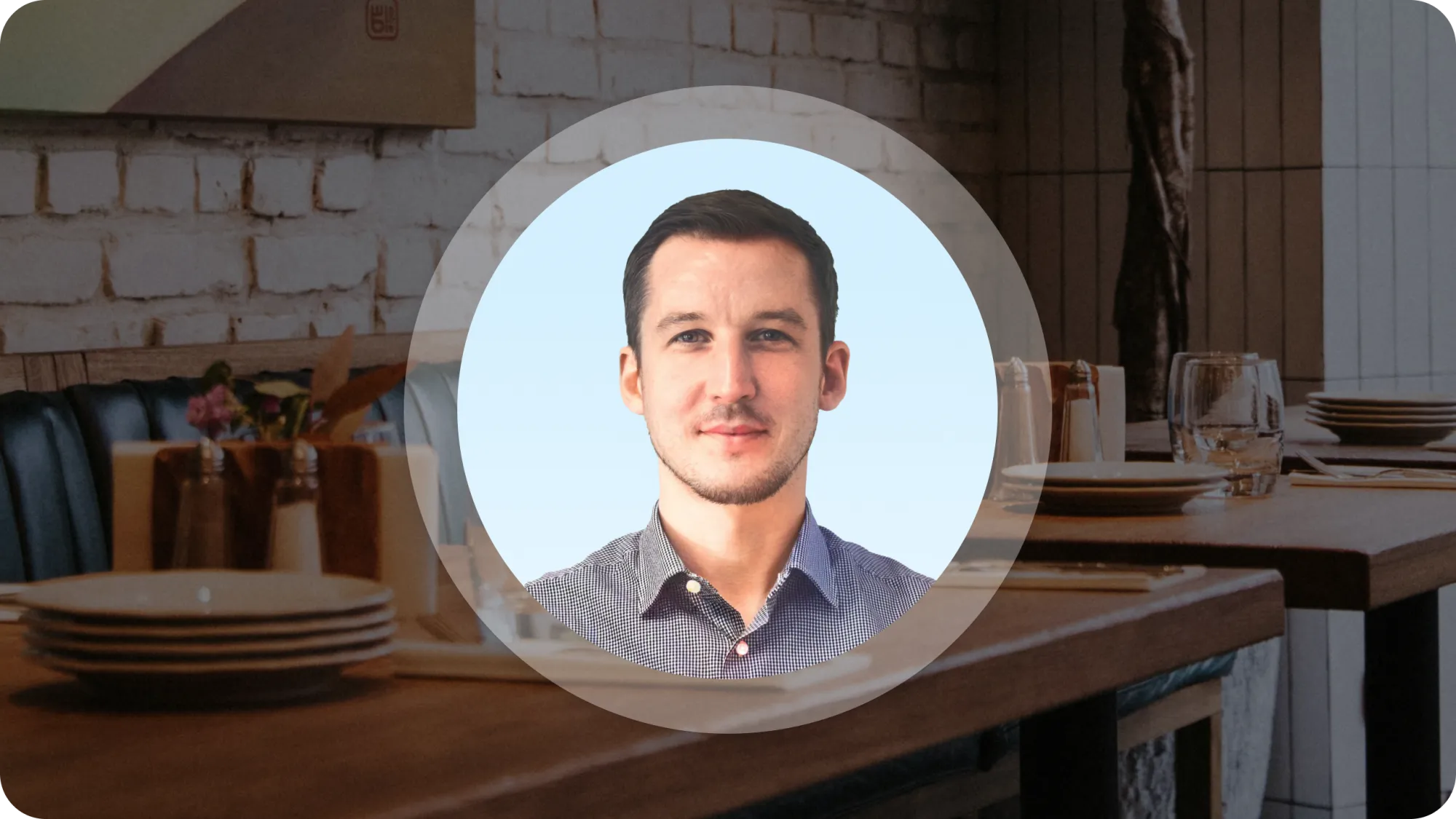 Christopher Conaghan's headshot on a stock photo of a restaurant.